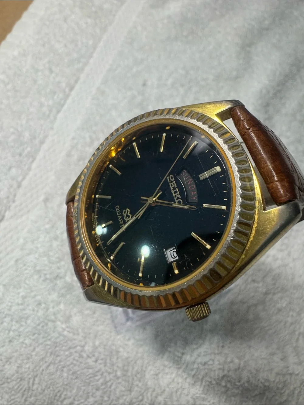 Seiko Black Dial Watch with Gold Accents and Brown Leather Strap